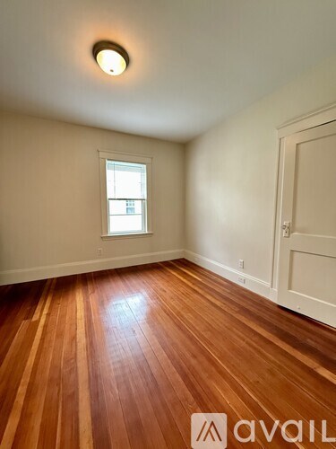A room with wooden floors and a window.