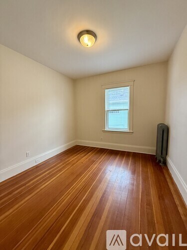 A room with wooden floors and a window.