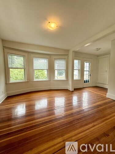 A room with wooden floors and windows.