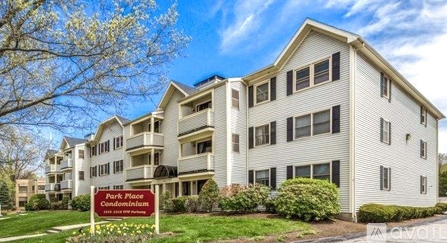 A large white building with a sign that says Park Place Condominiums.