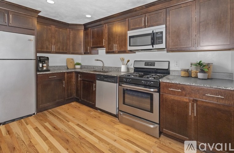 A kitchen with wooden cabinets and a white refrigerator.