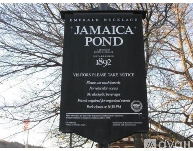 A sign for Jamaica Pond in Emerald Necklace warns visitors of the rules.