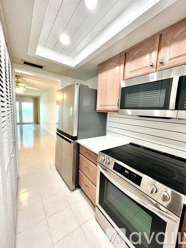 A kitchen with a stove top oven and microwave above it.