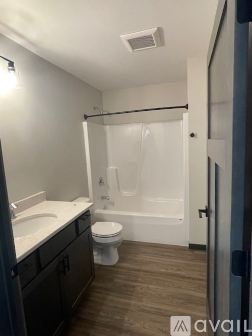 A bathroom with a toilet, sink, and bathtub.