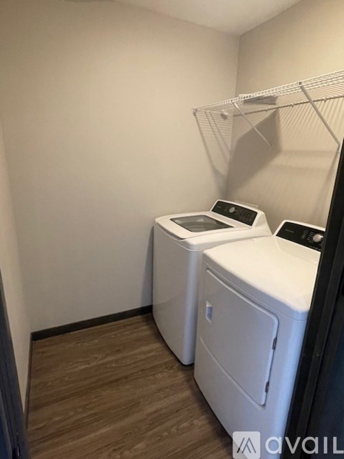 A small laundry room with a washer and dryer.
