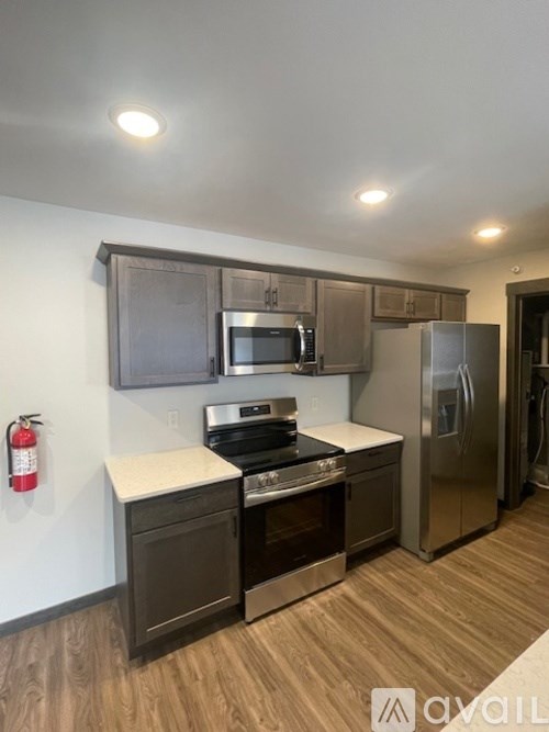 A kitchen with a stove, oven, and refrigerator.