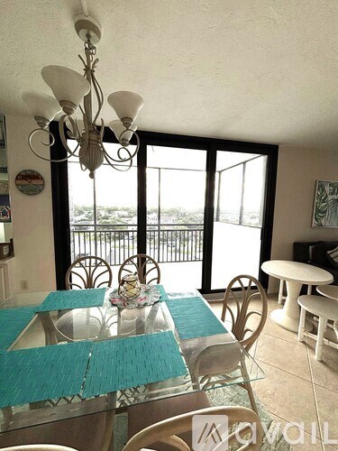 A dining room with a glass table and chairs.