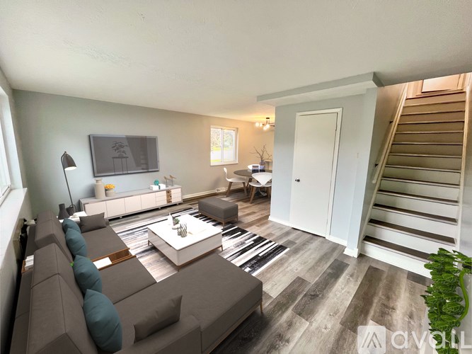 A living room with a grey couch and a coffee table.
