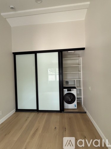 A room with a washing machine and a dryer in it.