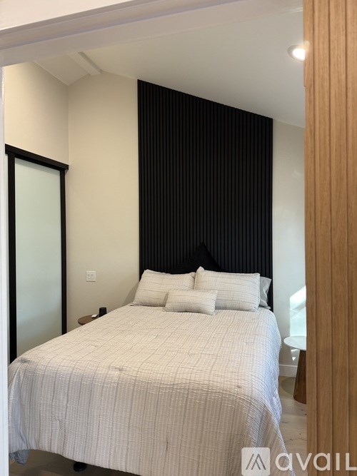 A kitchen with wooden floors and white cabinets.