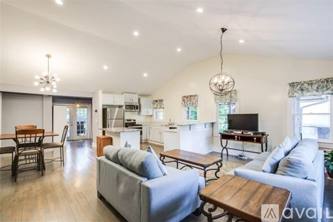A living room with a grey couch and a wooden coffee table.