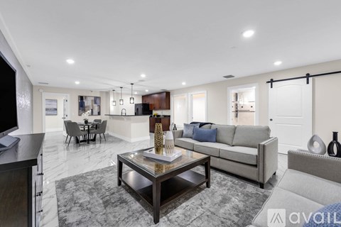 A modern living room with a coffee table in the center.
