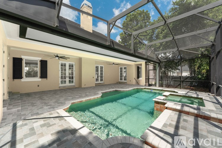 A pool area with a glass roof and a tiled floor.