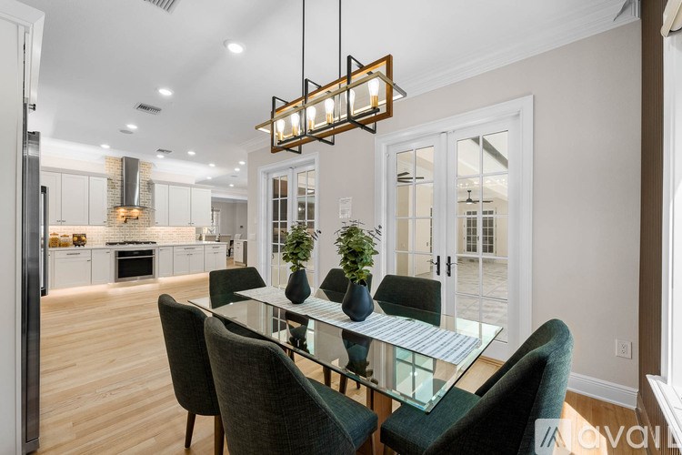 A modern dining room with a glass table and chairs.