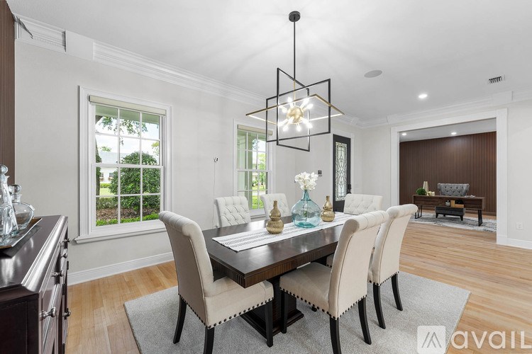 A modern dining room with a large table and chairs.