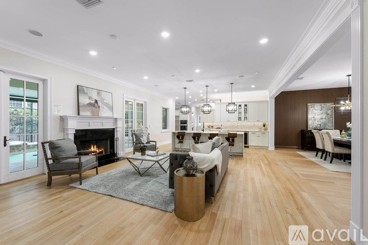 A spacious living room with a fireplace and a dining area.