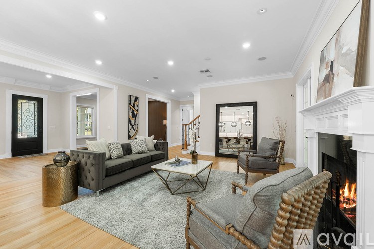 A living room with a grey sofa, a fireplace, and a coffee table.
