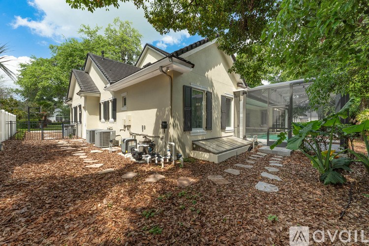 A house with a front yard covered in leaves.