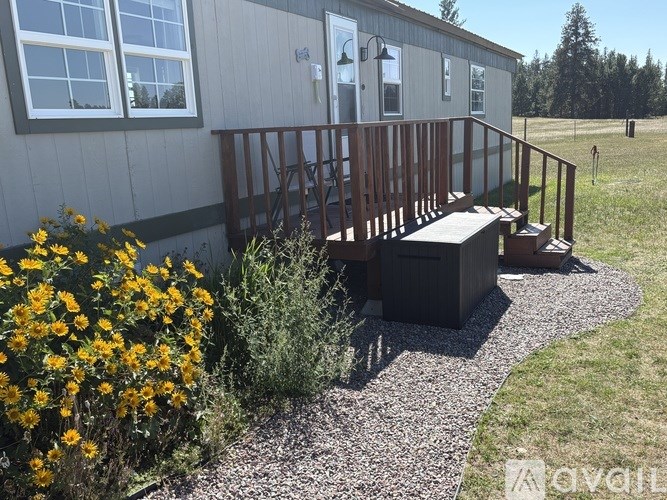 A house with a deck and a gravel pathway.