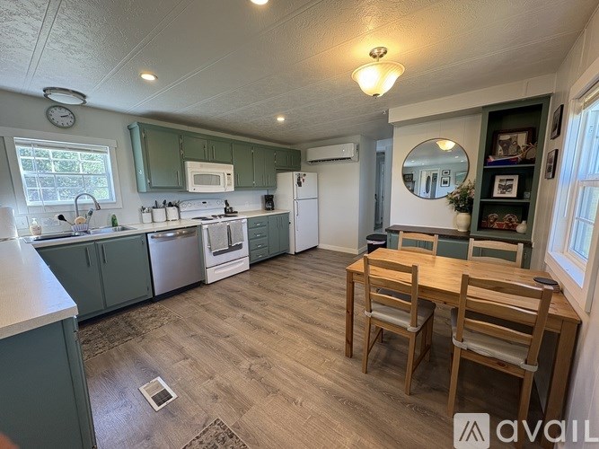 A kitchen with a dining table and chairs.
