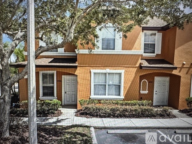 A row of brown chairs are lined up in a white room.