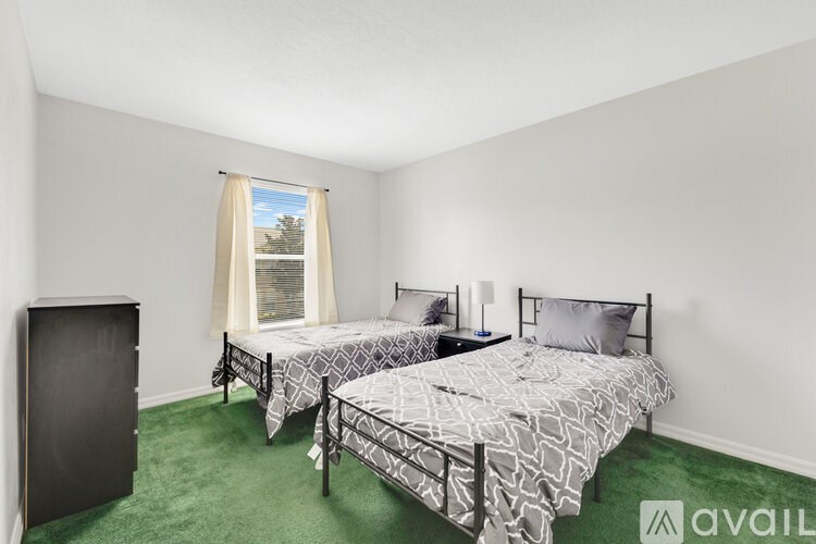 A bedroom with two beds and a wardrobe.