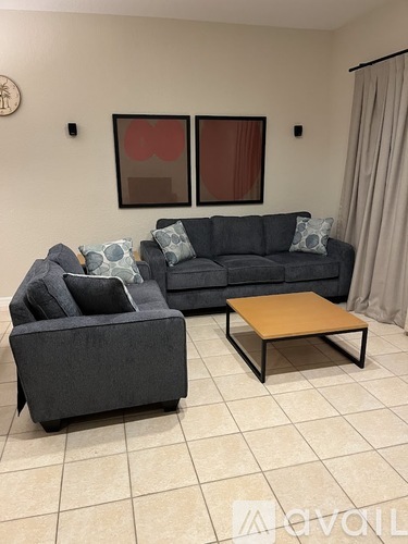 A living room with a dining table and chairs.