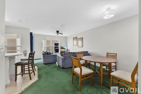 A living room with a dining table and chairs.