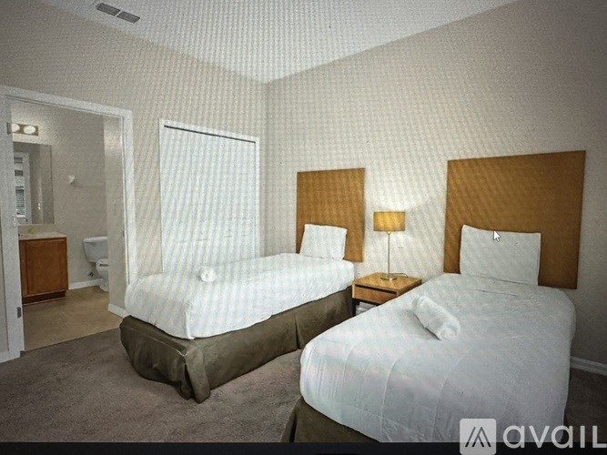 A living room with a grey couch and a television.