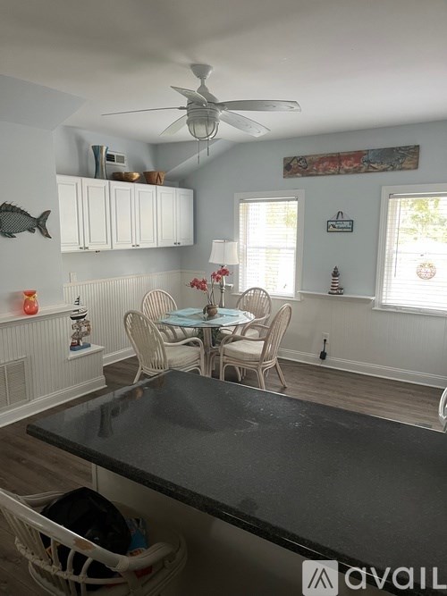 A dining room with a table and chairs.