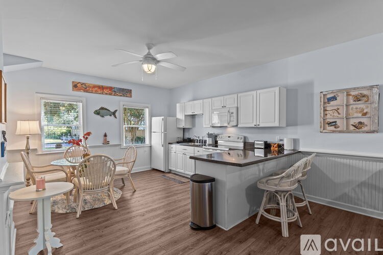 A kitchen with a dining table and chairs.