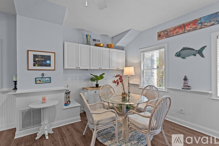 A dining room with a glass table and chairs.