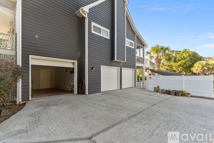 A two-story house with a garage and a driveway.