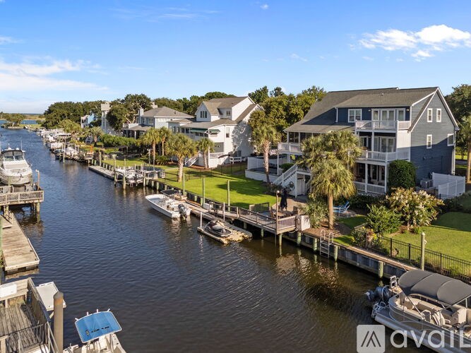 A row of houses are situated on the side of a body of water.