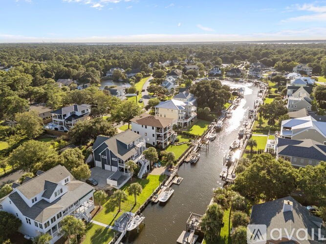 A bird's eye view of a residential area with houses and a canal.