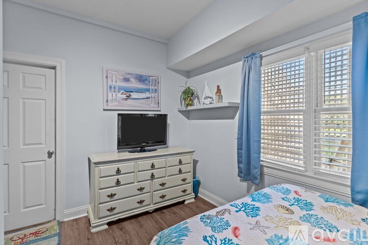 A bathroom with a toilet, sink, and mirror.