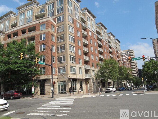 A street view of a city with a crosswalk and a building in the background.