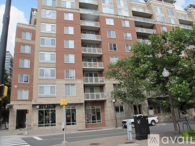 A tall building with a balcony on the second floor.