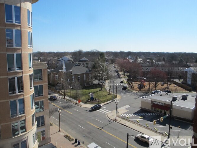 A view of a street from a high vantage point with cars and buildings.