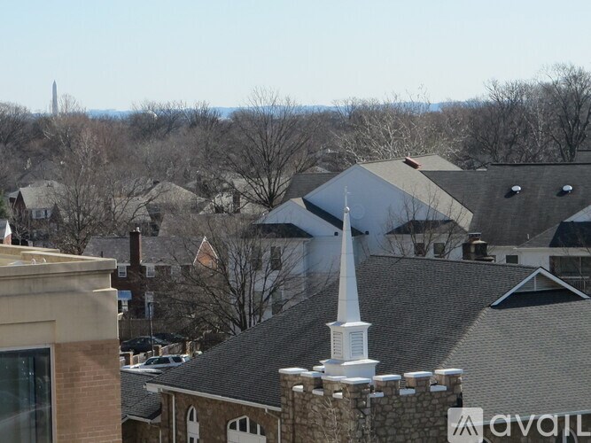 A view of a town with a church steeple in the foreground.