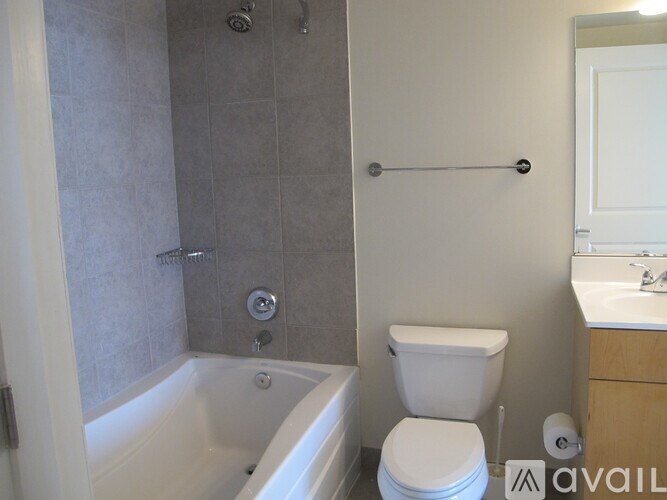 A bathroom with a toilet, sink, and bathtub.