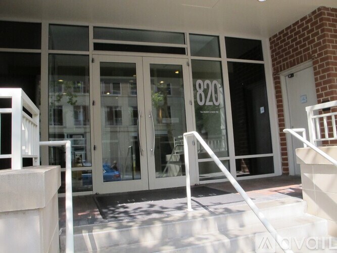 The image shows a set of double doors with a glass panel and the number 820 on it.