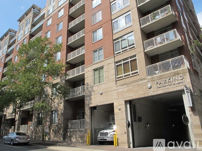 A tall building with a parking garage entrance.
