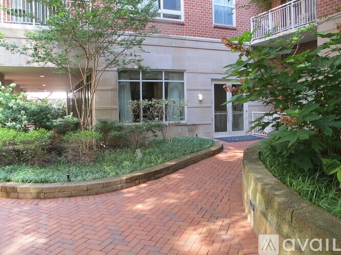 A brick pathway leads to a building entrance.