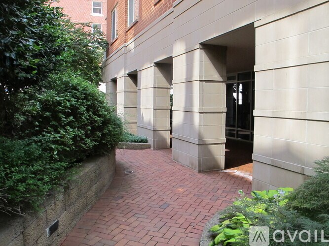 A brick pathway leads to a building entrance.