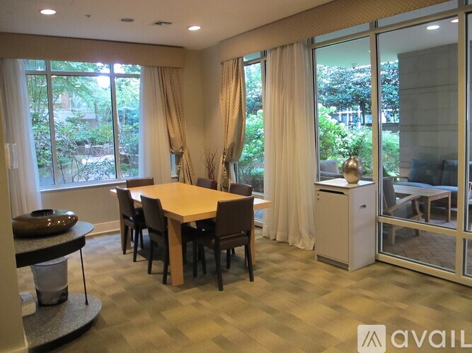 A dining room with a table and chairs.
