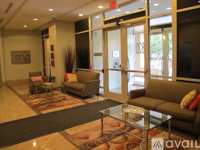 A living room with a couch, chairs, and a coffee table.