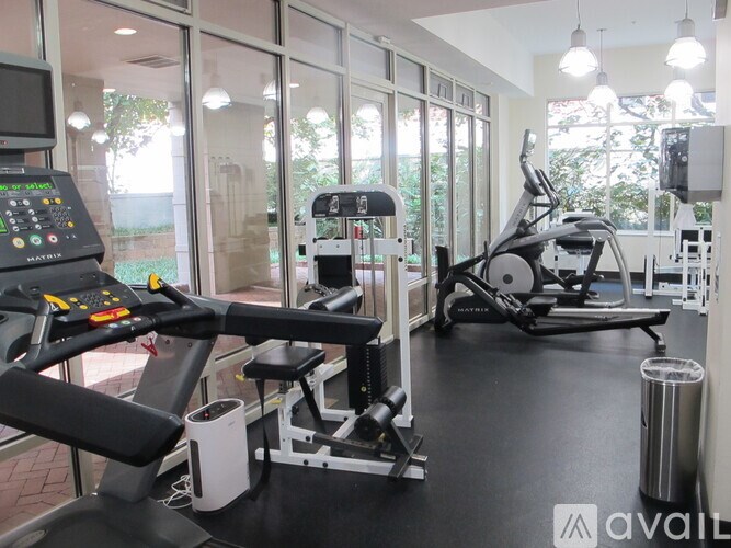 A gym with treadmills, elliptical machines, and other exercise equipment.