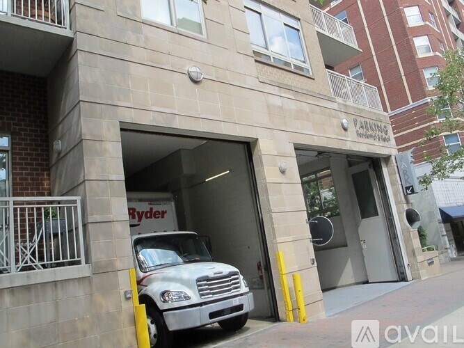 A white van is parked in a garage entrance.