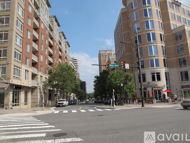 A street view with buildings on both sides and a crosswalk in the foreground.